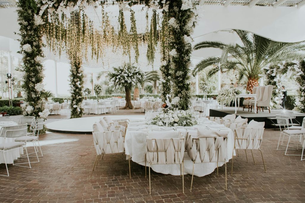 Stunning outdoor wedding setup featuring floral decorations, elegant seating, and ambient lighting.